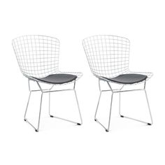 two white chairs sitting next to each other