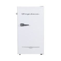 a white refrigerator freezer sitting on top of a white floor next to a wall