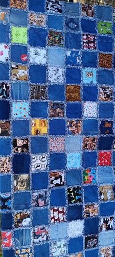 a blue patchwork quilt with many different pictures on it