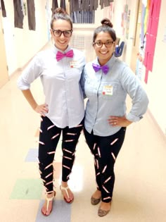 two women standing next to each other in a hallway