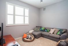 a living room filled with furniture and a flat screen tv