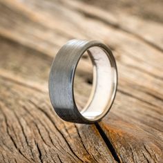 a wedding ring sitting on top of a wooden table