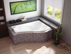 a bathroom with a large jacuzzi tub next to a window on the wall