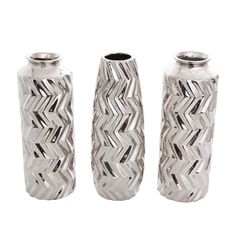 three silver vases sitting next to each other