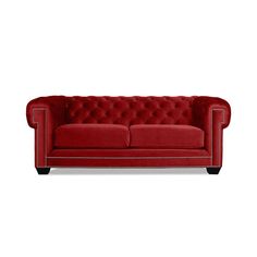 a red couch sitting on top of a white floor