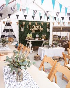 tables and chairs are set up for an outdoor wedding reception with welcome signs on the wall