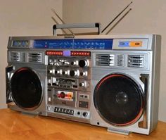 an old fashioned boombox sitting on top of a wooden table