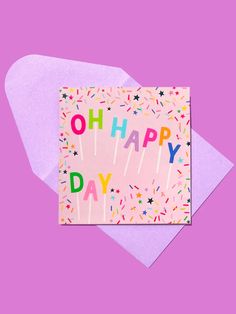 a pink card with the words oh happy day on it and sprinkles