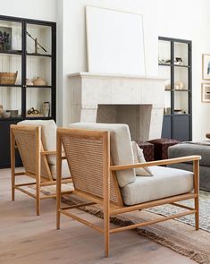 a living room filled with furniture and a fire place in the middle of the room