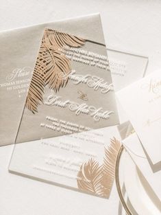 the wedding stationery is laid out on top of each other, including an envelope