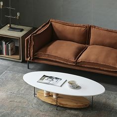 a living room with a couch, coffee table and bookshelf on the floor