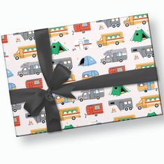 a gift wrapped in wrapping paper with black ribbon