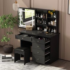 a black vanity with drawers, mirror and stools in front of a wall mounted plant