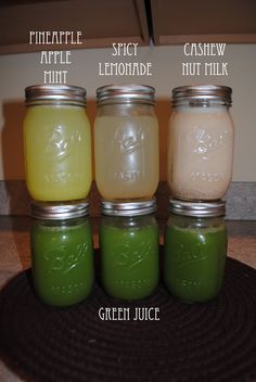 four jars filled with different colored liquids