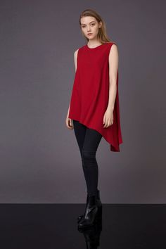 Red asymmetrical shirt, red flare blouse, asymmetrical shirt, asymmetrical blouse, Christmas top, minimalist style, gift for her Red long sleeveless blouse has a romantic silhouette , asymmetric cut which gives light and tender look. This is modern feminine top with extremely asymmetrical lower line. Prolonged left angle and flared cut allows fabric to flow in large elegant drapes and form a beautiful wavy contour. Polyester 100% Handmade item Loose fit Asymmetrical cut Flare silhouette Model is Solid Asymmetrical Hem Top For Layering, Modern Asymmetrical Hem Top For Fall, Casual Asymmetrical Solid Color Blouse, Versatile Fitted Blouse With Asymmetrical Hem, Versatile Party Tops With Asymmetrical Hem, Party Tops With Asymmetrical Hem, Fitted Blouse With Asymmetrical Hem, Modern Fall Tops With Asymmetrical Neckline, Solid Asymmetrical Hem Top For Work