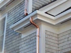 an image of a copper gutter on the side of a house