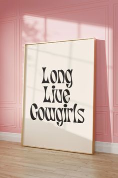 a white framed poster with the words long live cougirs on it in front of a pink wall