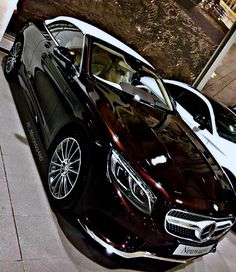 two cars parked next to each other in a garage