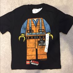 a black t - shirt with an image of a lego man on it