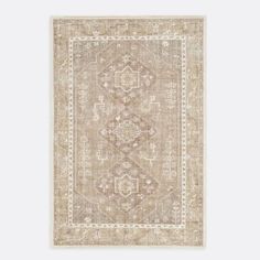 a beige rug with an ornate design on the front and back side, in neutral tones