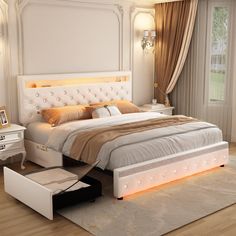 a bedroom with a bed, dresser and night stand in the middle of the room