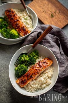 two bowls filled with rice, broccoli and salmon