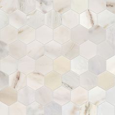 a white and beige marble tile with hexagonal tiles on the bottom, in different shades