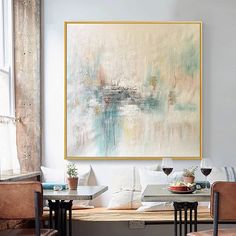 a painting hanging on the wall in a dining room