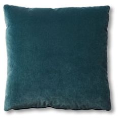 a dark green pillow on a white background