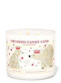 a white candle with two bears on it and the words crushed candy cane written in red