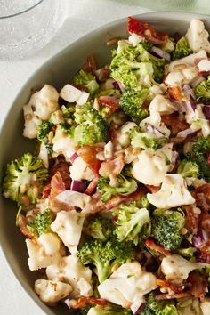 a bowl filled with broccoli, cauliflower and bacon