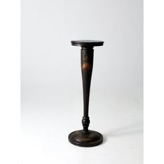 an old fashioned black candle holder on a white background