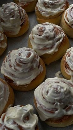 there are many cinnamon rolls with icing on them