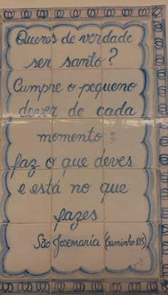 some tiles with writing on them in blue and white