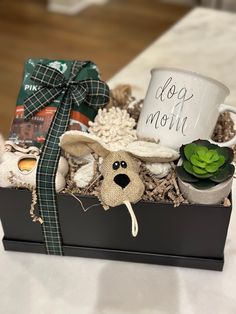 a dog mom gift box with a coffee mug and stuffed animals