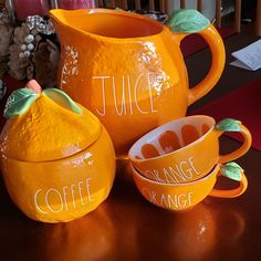 three oranges with words painted on them sitting on a table next to each other