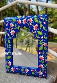 a blue frame with flowers painted on it