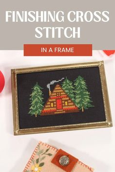 the finished cross stitch pattern is displayed in a frame with an ornament on it