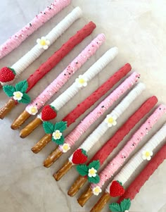 there are many strawberries and pretzels on sticks