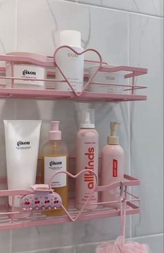 a pink shelf filled with different types of personal care products on top of a tiled wall