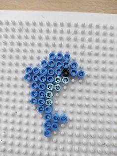 a lego board with blue and black circles on it