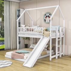 a white bunk bed with a slide in front of it