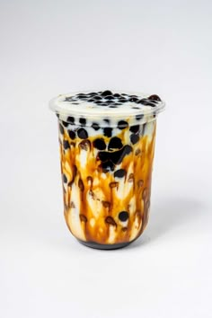 a glass cup with black and white designs on it