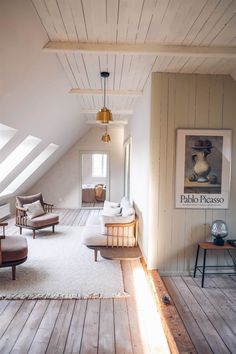 a living room filled with furniture and white carpeted flooring on top of wooden floors