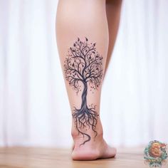 a woman's foot with a tree tattoo on it