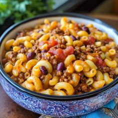 a bowl filled with chili macaroni and cheese