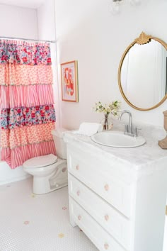 a bathroom with a sink, toilet and shower curtain