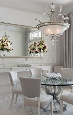 a dining room table with chairs and a chandelier