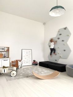 a child's bedroom with climbing wall and toys