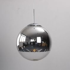 a chrome ball hanging from the ceiling in an office